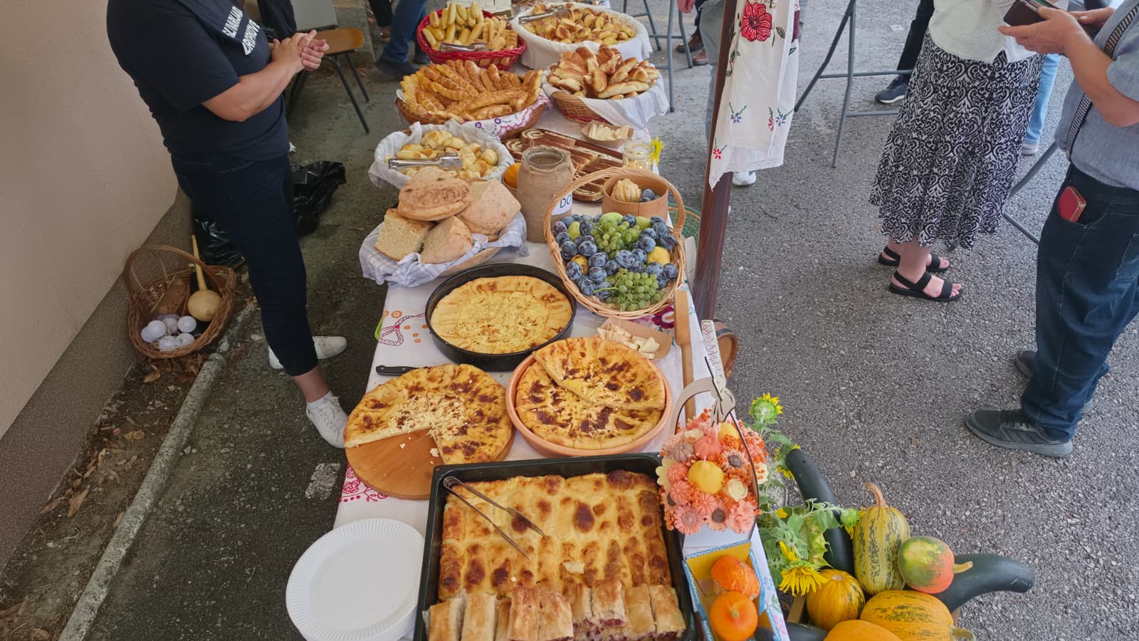 Dugi stol s domaćim delicijama pod suncobranima